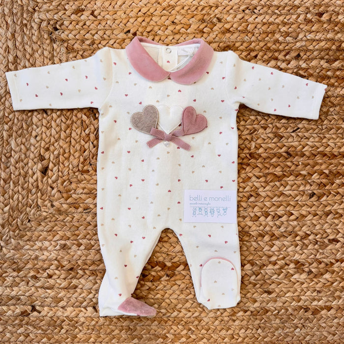 Tutina per neonata in caldo cotone bianco e ciniglia rosa con cuori sul davanti.