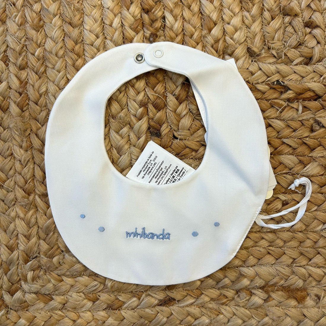 Bavaglino neonato bianco con ricamo “ninnanda” in azzurro e pois ricamati.
