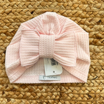 Turbante rosa per neonata in tessuto nido d’ape con maxi fiocco