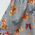 Completo bimba con cardigan rosso in misto lana, fiocchi blu e gonna tartan grigia con orsetti.