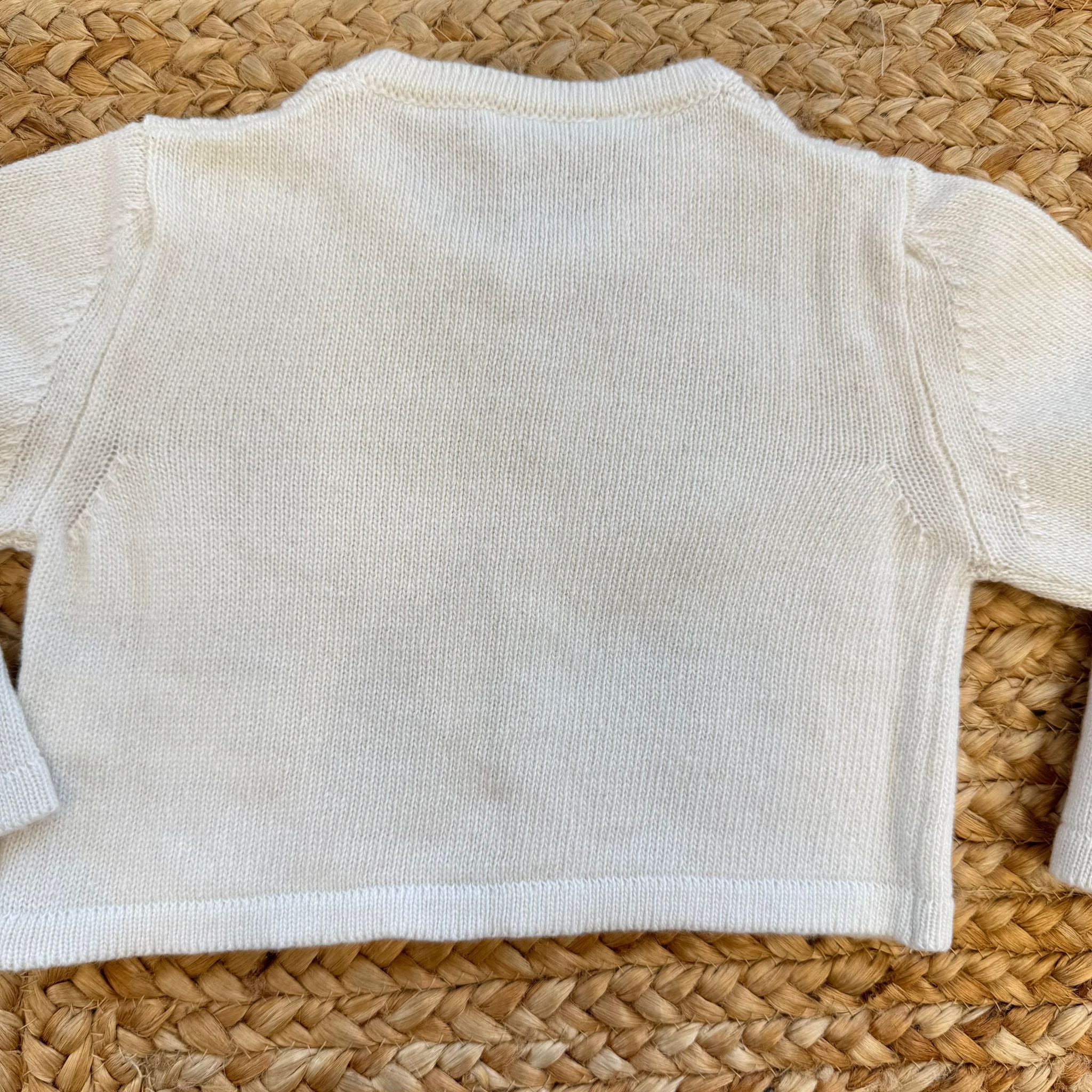 Cardigan neonato panna con trecce sottili e bottoni madreperla