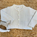 Cardigan neonato panna con trecce sottili e bottoni madreperla