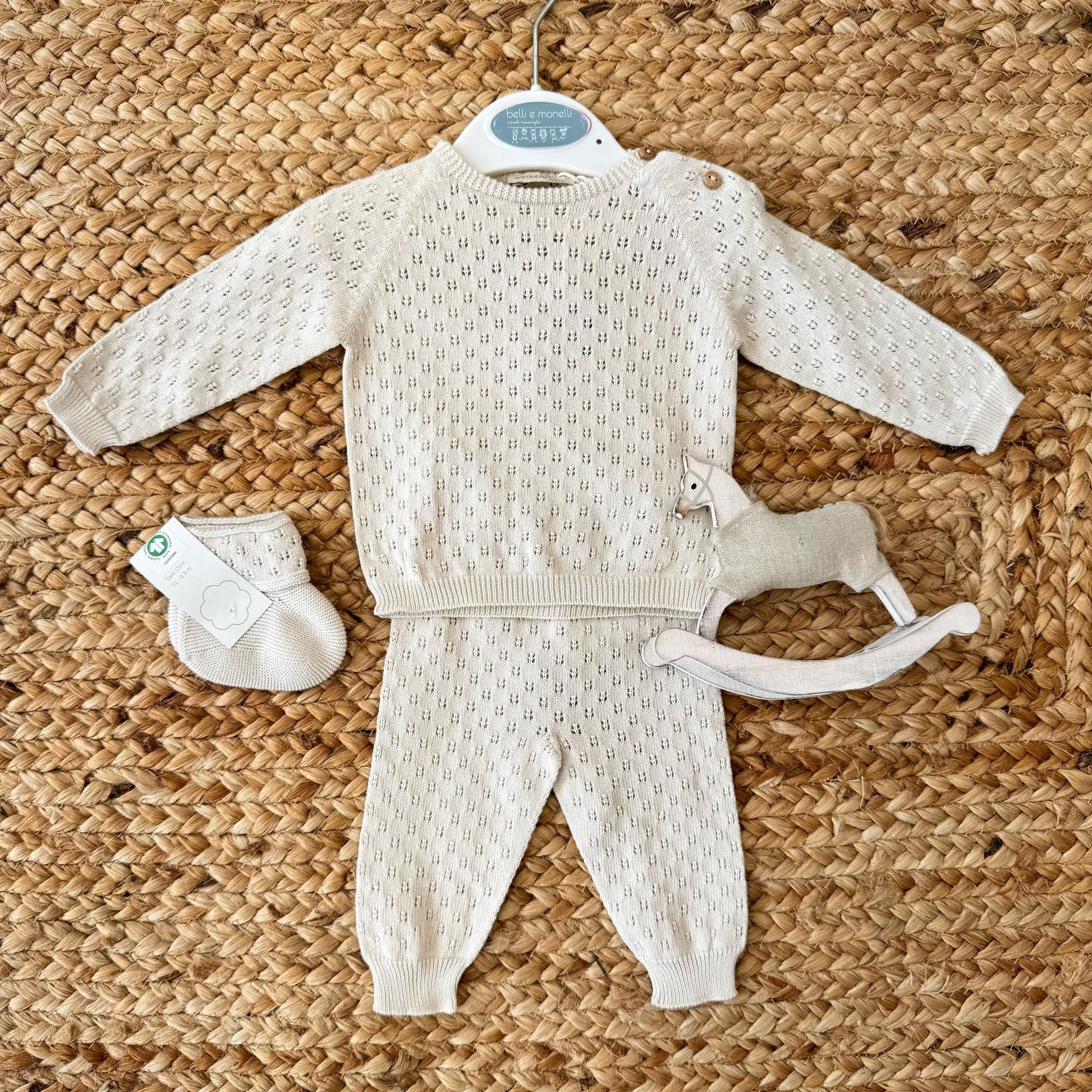 Set nascita neonata in filo di cotone, composto da maglia traforata con bottoncini in legno e pantaloni coordinati. Perfetto per l’uscita dalla clinica e il primo corredino.