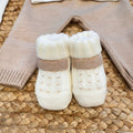 Copertina in lana con orsetto bouclé e fiocco panna applicato.