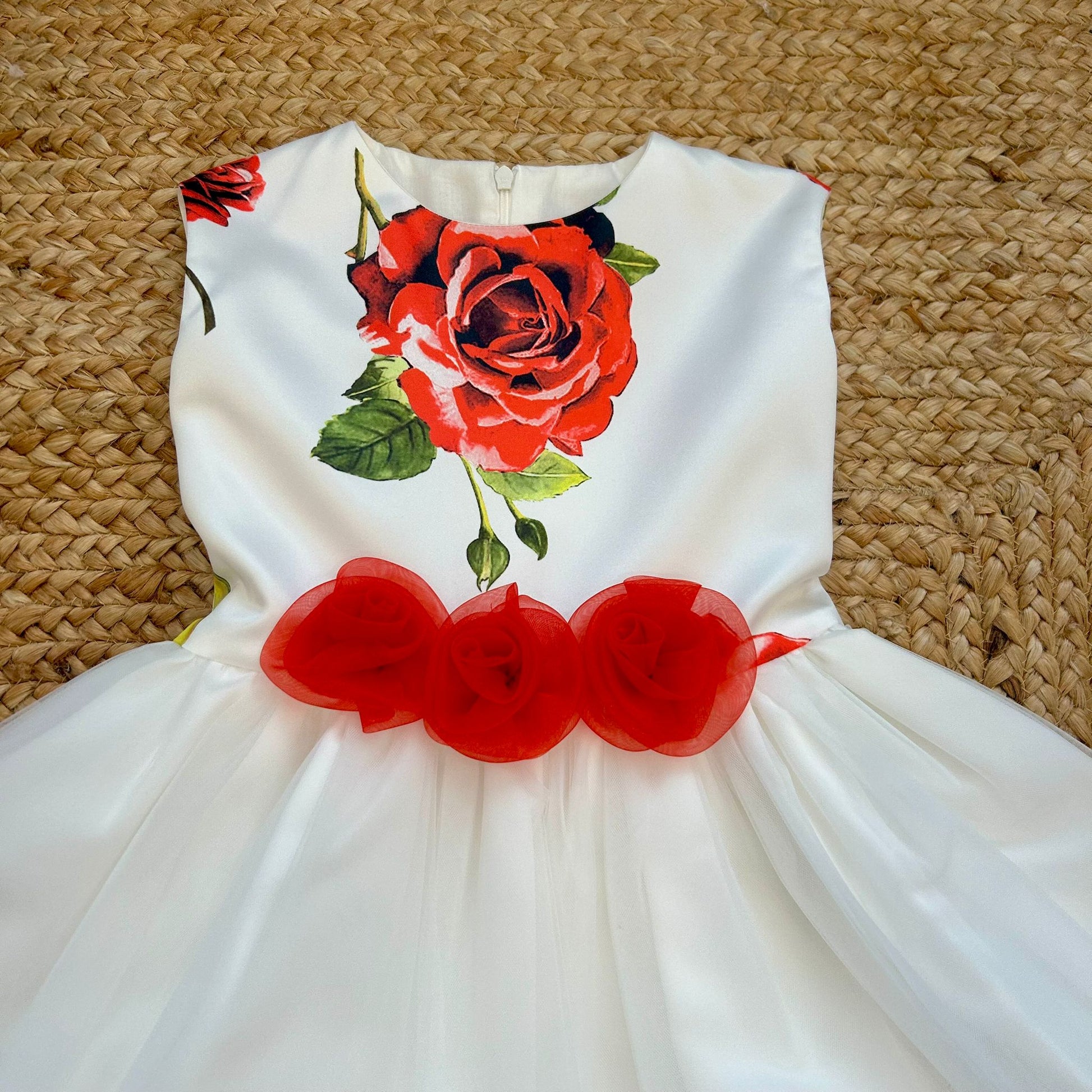Dettaglio corpetto con stampa rose rosse su abito elegante bimba
