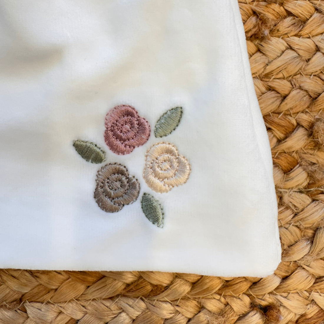 Cappellino neonata in ciniglia bianca con ricamo floreale