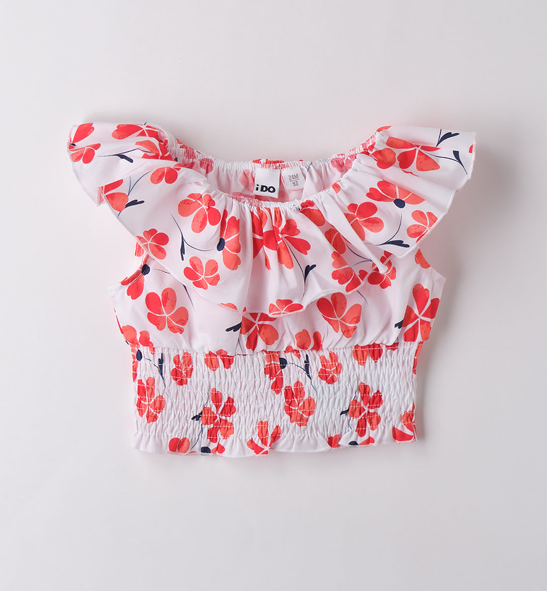 Top estivo per bambina con stampa fiori corallo e balza sulle spalle, vista frontale.