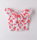 Top estivo per bambina con stampa fiori corallo e balza sulle spalle, vista frontale.