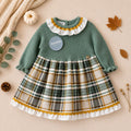 Vestito elegante bimba verde salvia con fantasia scozzese, ideale per cerimonie e occasioni speciali.