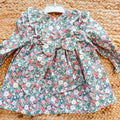 Abito bimba floreale con volant, pompon rosa e fiocco posteriore