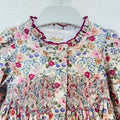 Abito bambina floreale in cotone con punto smock, colletto arricciato e dettagli bordeaux Kidivi.
