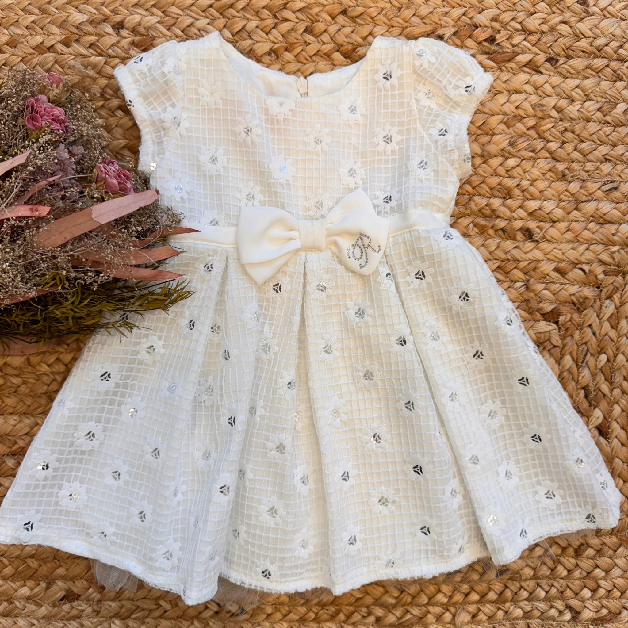 Vestito battesimo bambina panna con fiocco centrale e paillettes leggere.