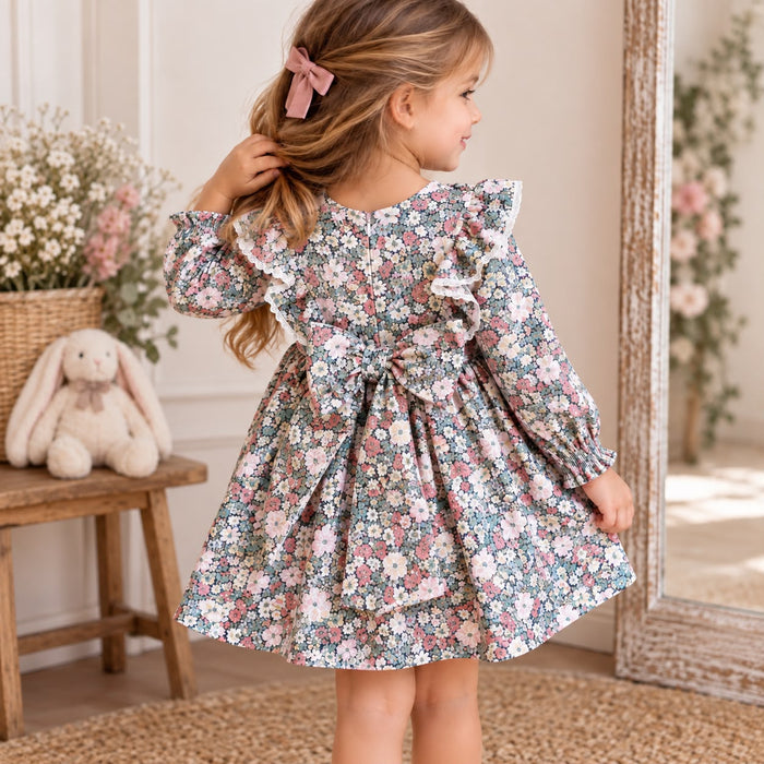 Abito bimba floreale con volant, pompon rosa e fiocco posteriore