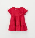 Abito bimba color fragola con fiore applicato e gonna a balze