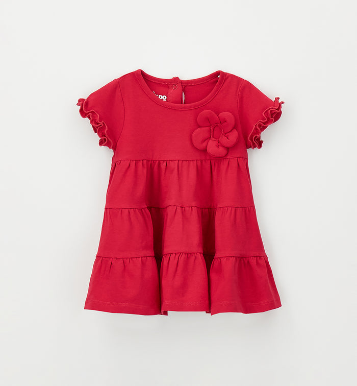Abito bimba color fragola con fiore applicato e gonna a balze