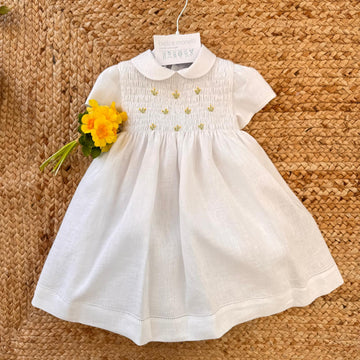 Abito bimba in lino bianco con punto smock e ricami floreali