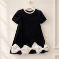 Abito elegante bambina nero con tre maxi fiocchi avorio e maniche a palloncino