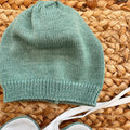: Cappellino neonato in maglia verde salvia, morbido e avvolgente
