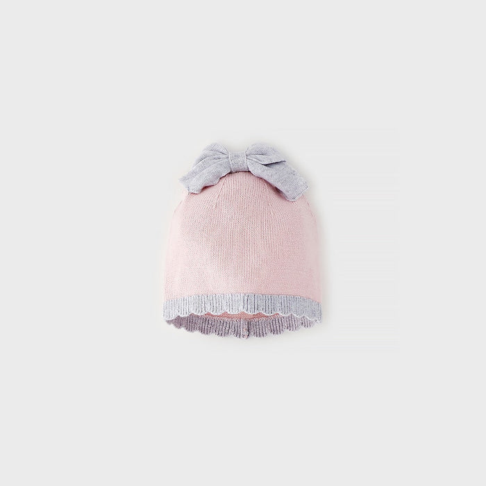 Cappellino neonata rosa in cotone e lana con fiocco a contrasto e bordo coordinato