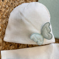cappellino bianco neonato con dettaglio farfalla verde