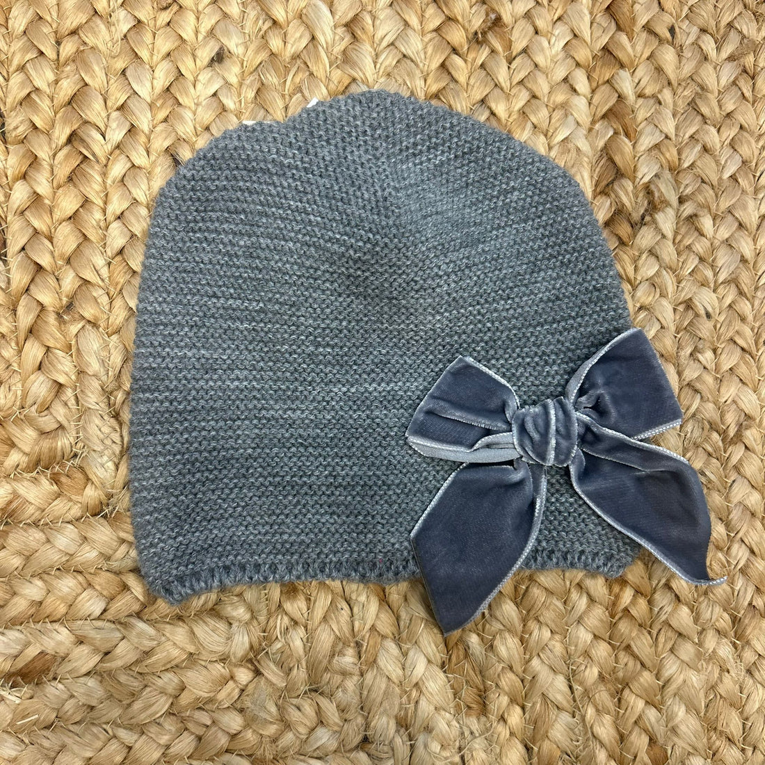 cappellino grigio in maglia con fiocco in velluto per bambina