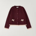 Cardigan bimba bordeaux con bottoni tasche e fiocchi beige