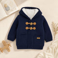 Cardigan bambino blu con cappuccio, interno morbido bianco e chiusura con alamari