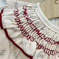 Vestitino neonata panna con fantasia floreale e colletto volant bordeaux
