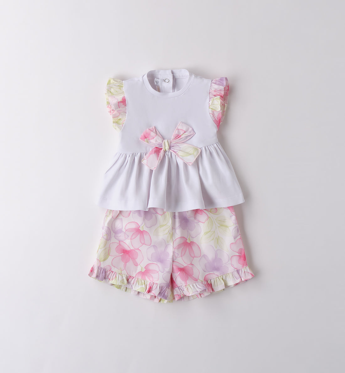 Completo bambina in cotone con top bianco e shorts floreali con balze.