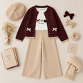 Cardigan bimba bordeaux con bottoni tasche e fiocchi beige