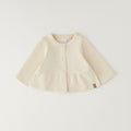 Giacca bimba in caldo cotone color panna con balza e chiusura frontale
