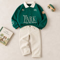 Completo bimbo con polo verde ricamata e pantalone panna