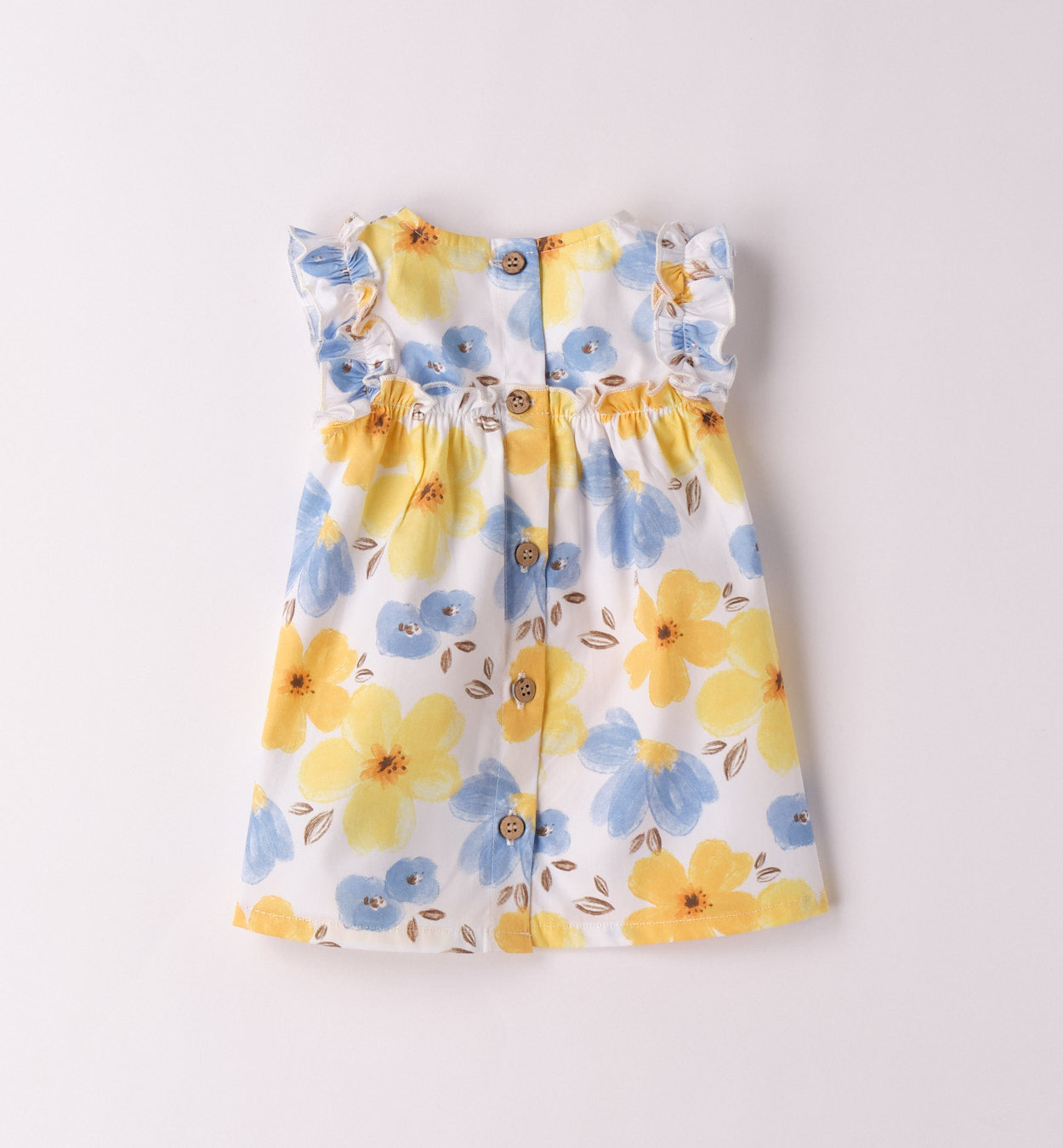 Dettaglio del vestito estivo per bambina con volant e stampa floreale vivace.