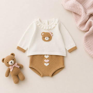 Tutina neonata rosa e grigio con fiocco, colletto bianco e finiture ai polsini per corredino nascita.