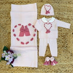 Coordinato neonata rosa in pura lana con fiocchi ciclamino.