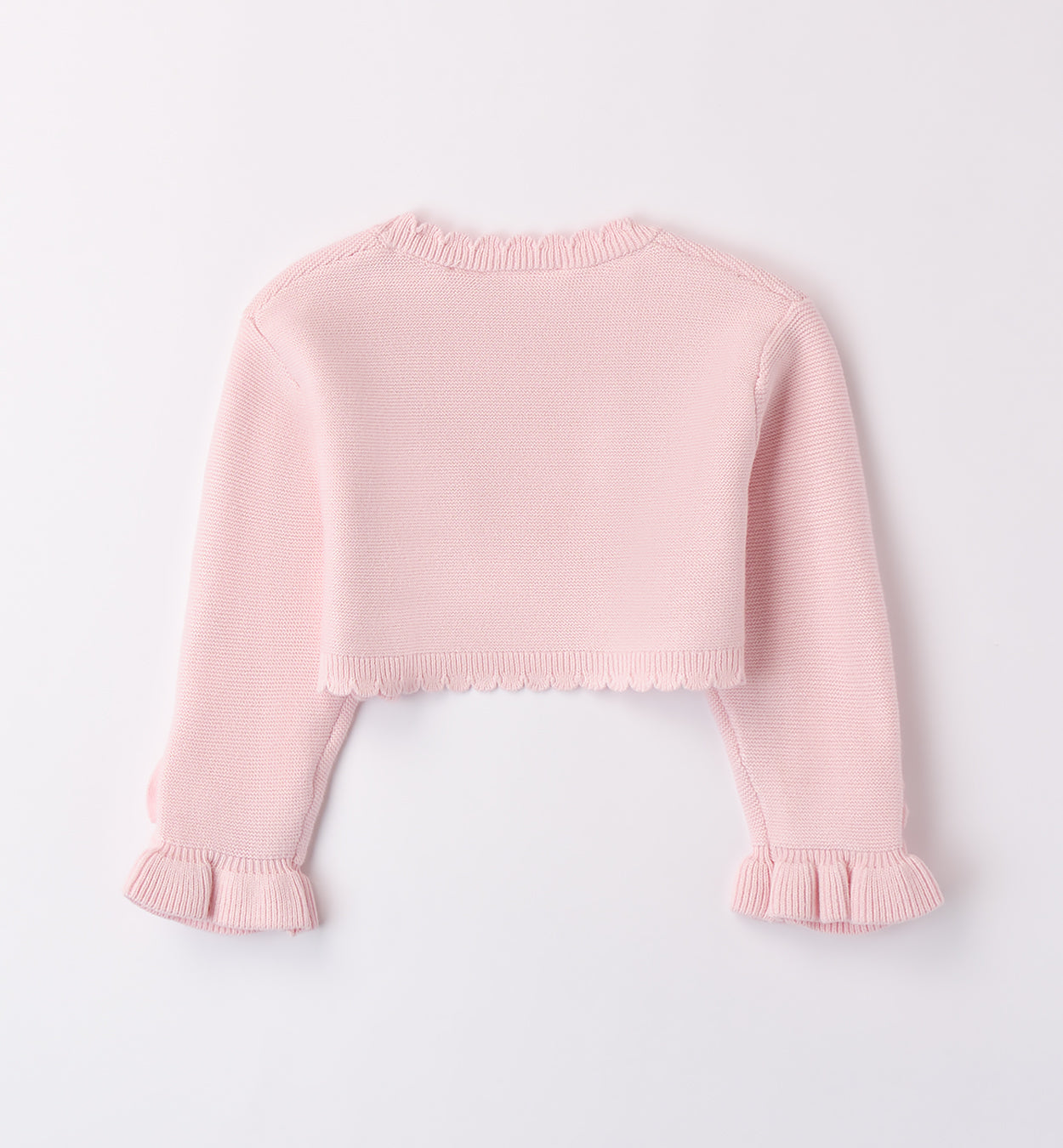 Coprispalle rosa cipria in maglia per bambina con dettagli floreali e bordo smerlato.