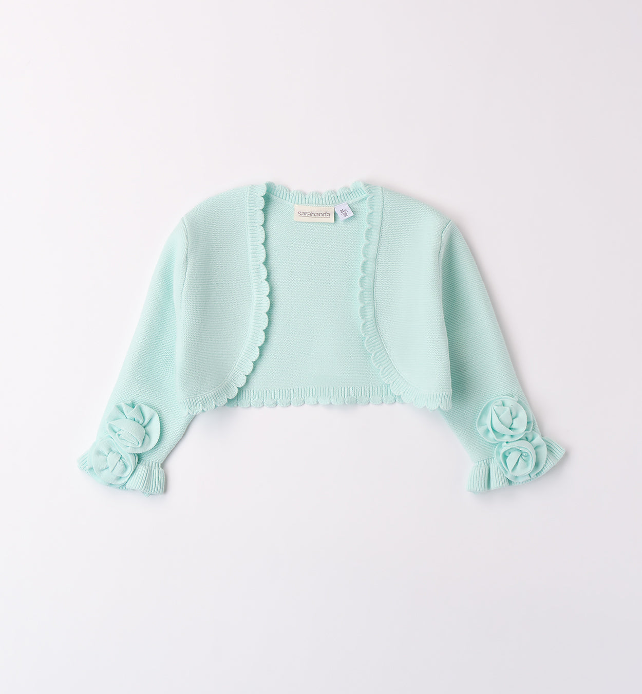 Coprispalle bambina in maglia verde acqua con fiori applicati e bordo smerlato.
