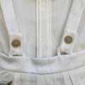 dettaglio body camicia panna con bretelle e bottoni