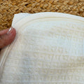 Accappatoio con cappuccio per bambina in cotone e bambù colore panna Made in Italy.