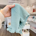 dettaglio coprispalle verde acqua lavorazione maglia