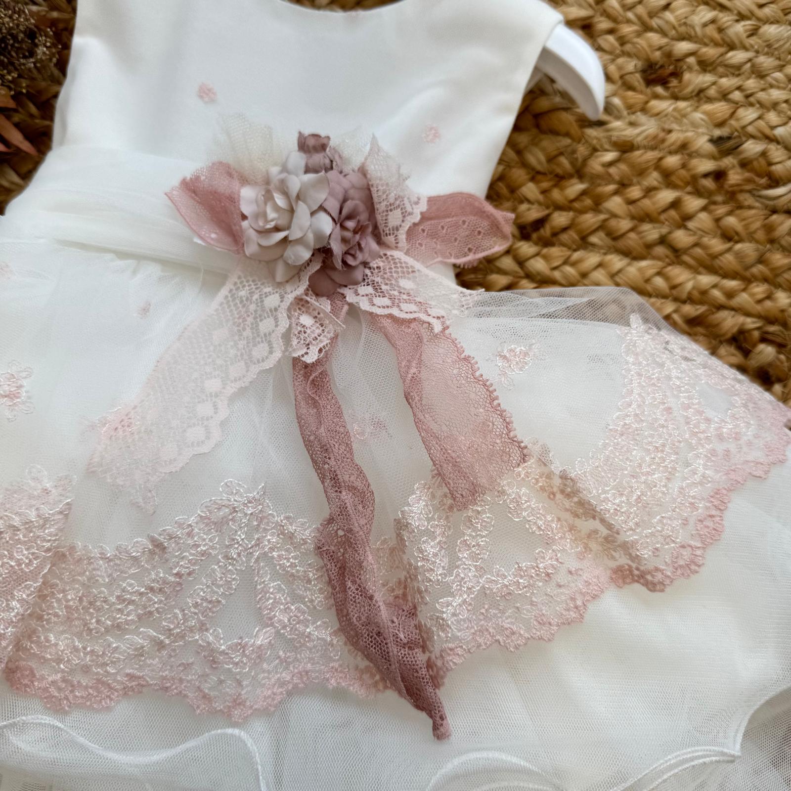 dettaglio applicazione floreale e nastri in pizzo rosa