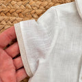 Dettaglio manica corta con bordo beige camicia battesimo bimbo
