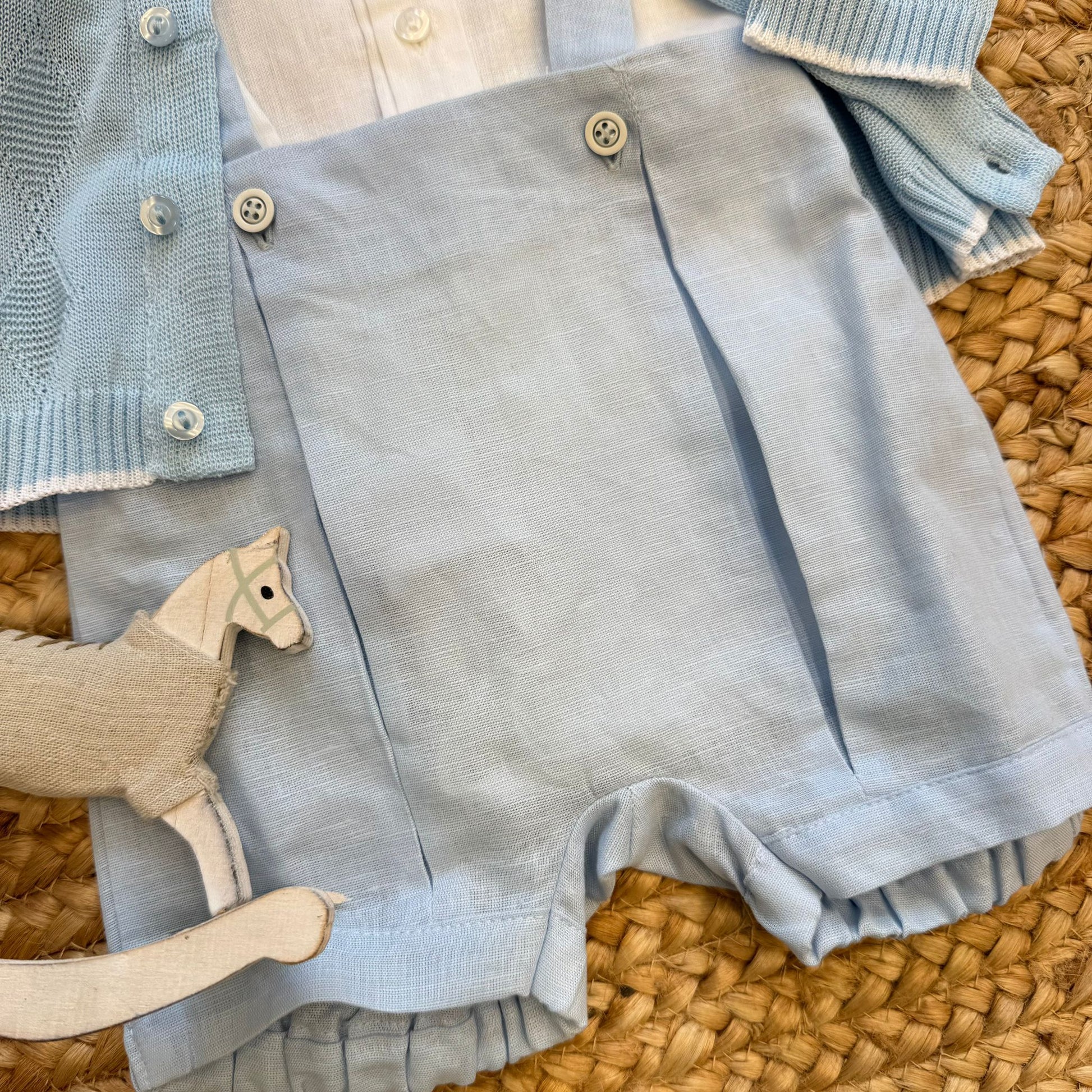 Dettaglio pantaloncino con pince e bottoni