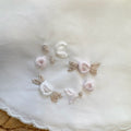 Bavetta neonata in cotone panna con ricamo floreale rosa e beige