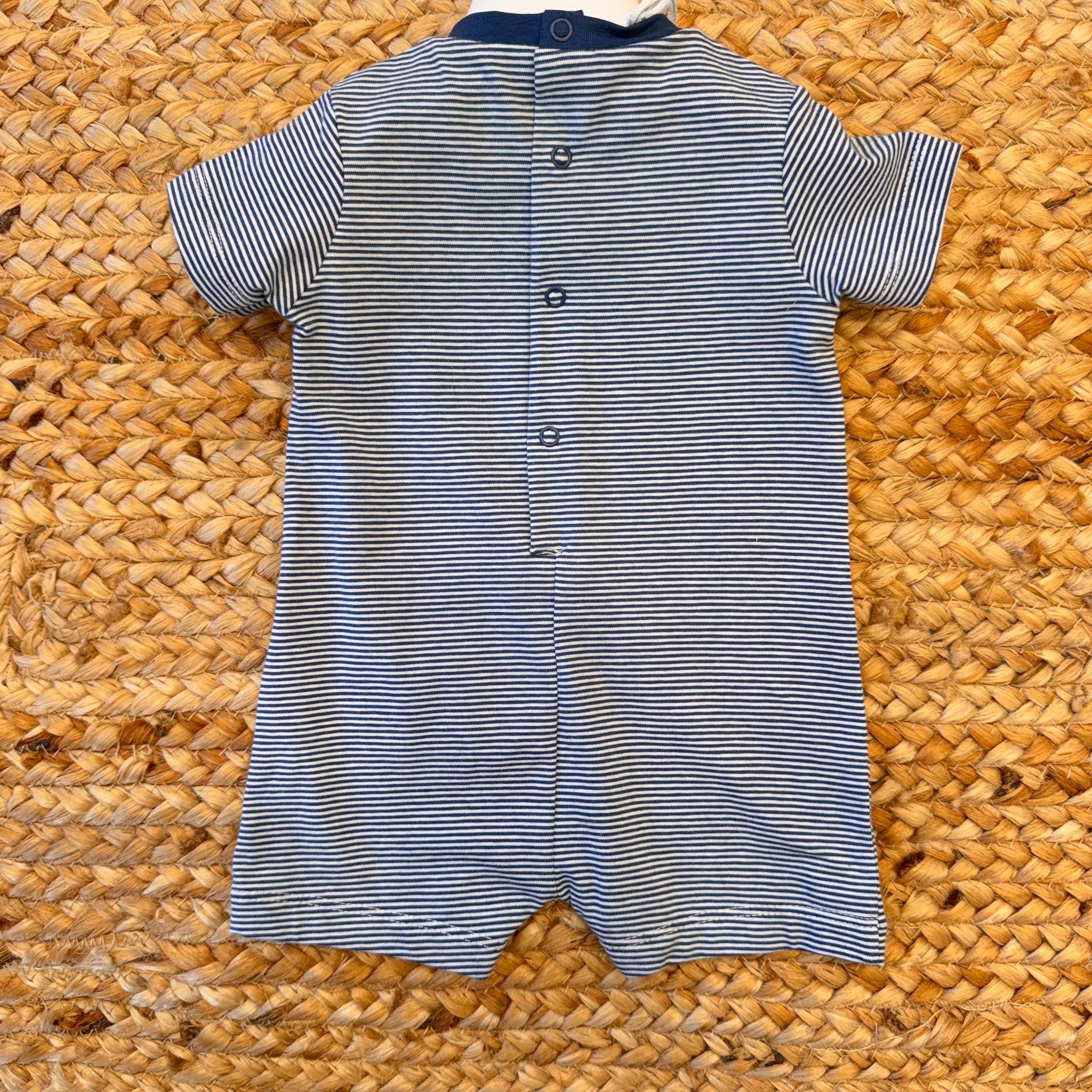 Pagliaccetto a righe blu con apertura retro a bottoni

