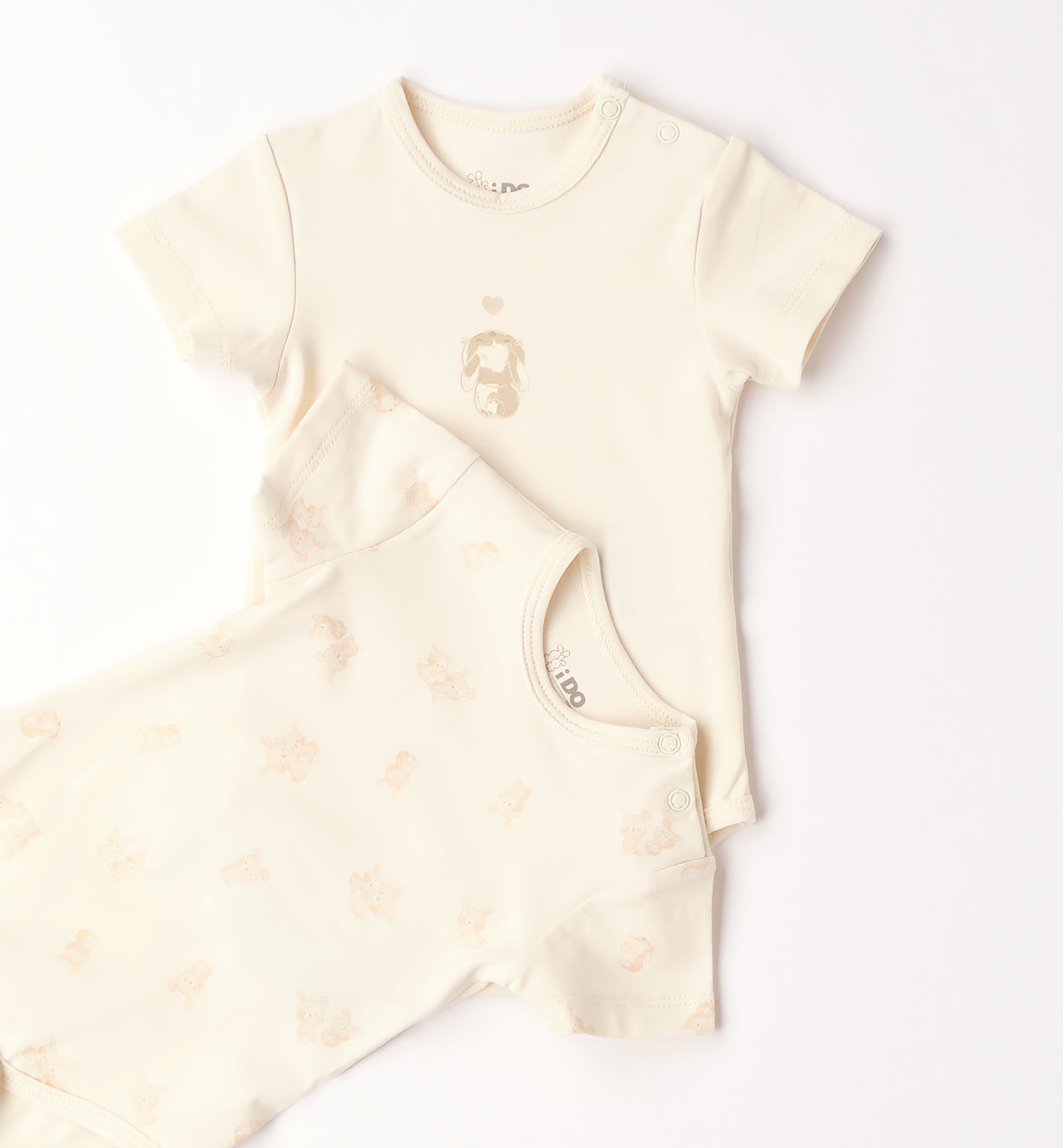 dettaglio stampa cucciolo body neonato panna