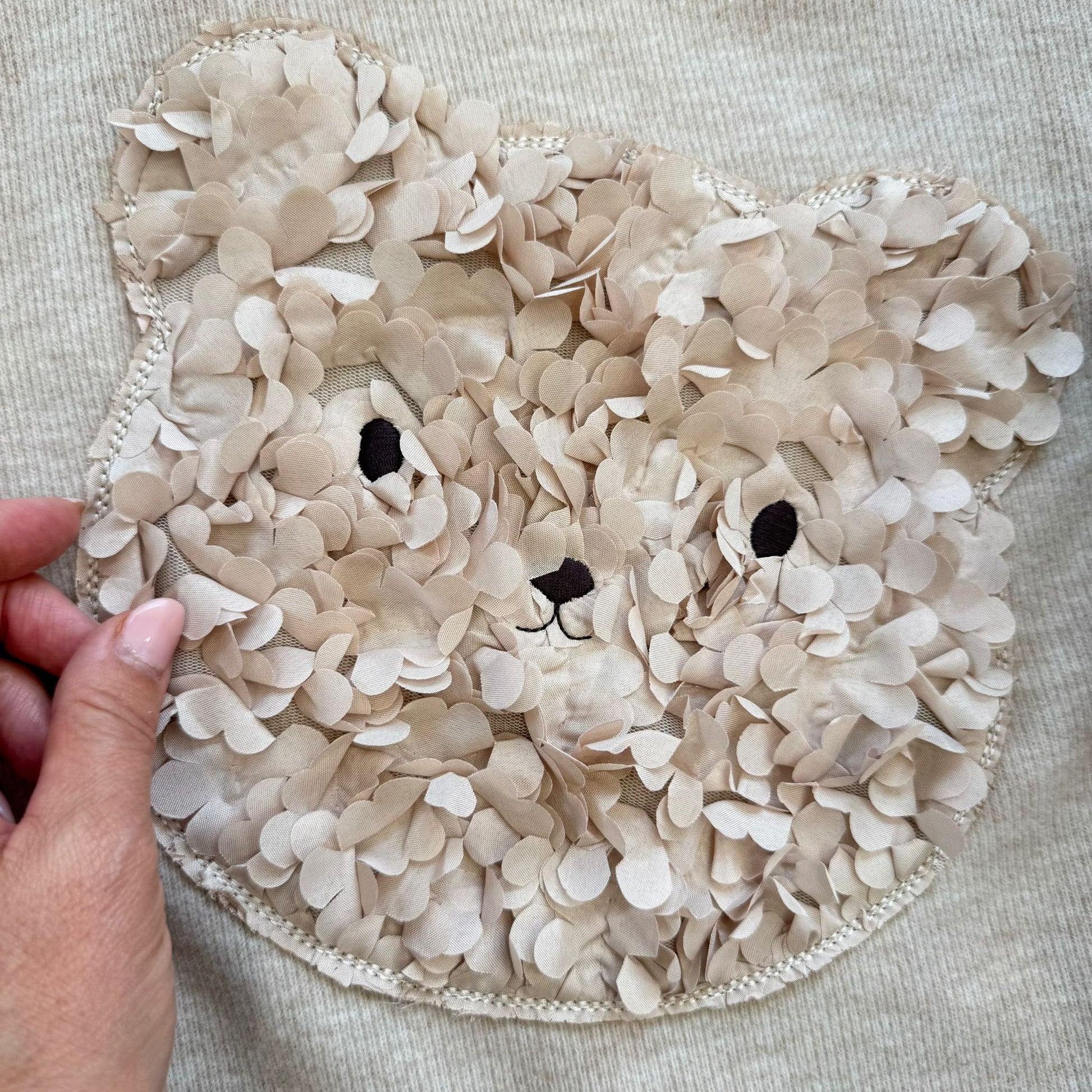dettaglio applicazione orsetto 3D floreale felpa bambina