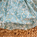 Pagliaccetto bimba in cotone floreale verde acqua con blusa bianca plumetis e colletto volant