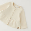 Giacca bimba in caldo cotone color panna con balza e chiusura frontale
