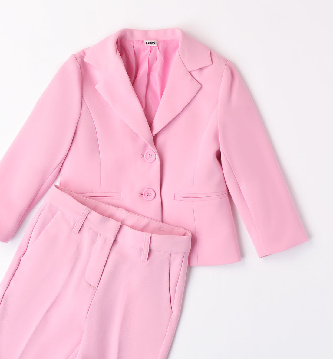 Blazer bambina rosa confetto con bottoni tono su tono e fiori decorativi.